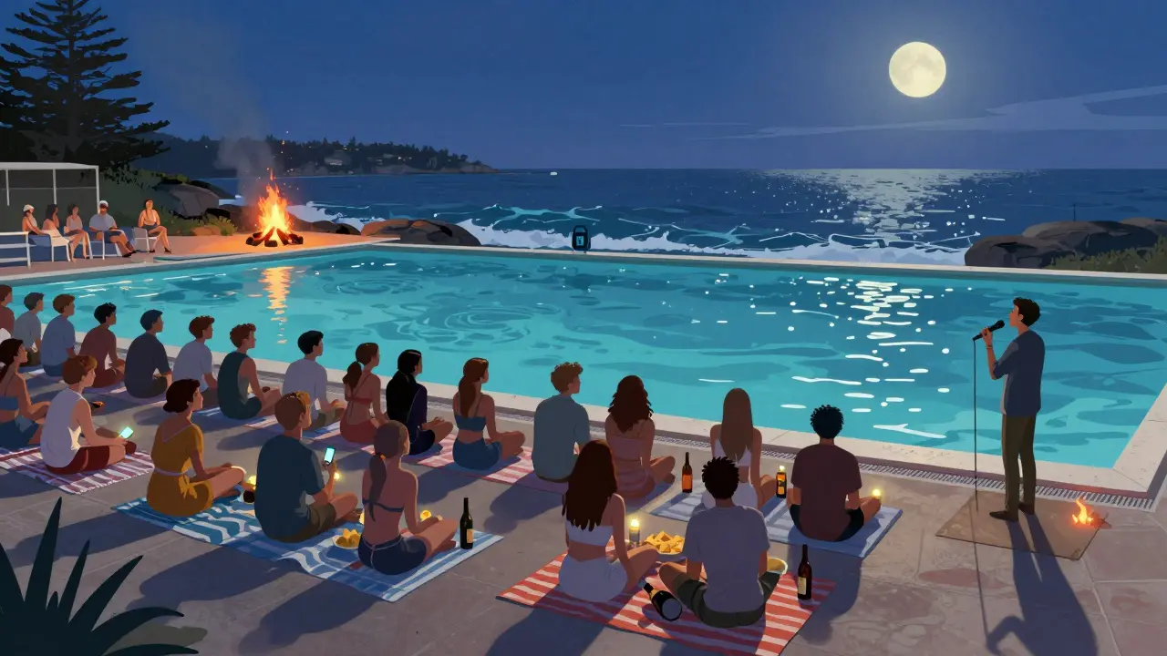 Evening gathering at Manly Ocean Pool with bonfire, blankets, and starlight under a quiet night sky.