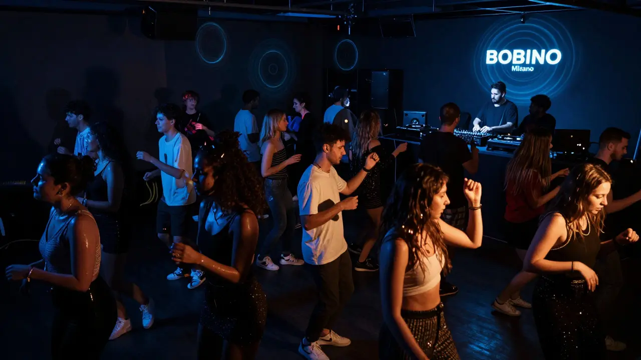 Packed dance floor at Bobino Milano with people moving to music under pulsing lights.
