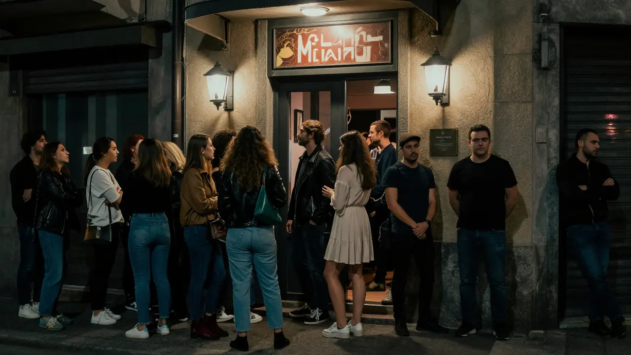 A long line of casually dressed people waiting outside Club Milano on a Saturday night.
